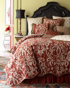 a bed with red and white comforter in a room