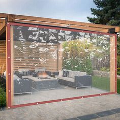 an outdoor living area with couches and fire pit