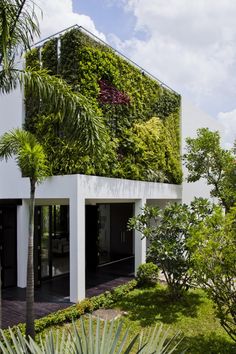 a house with plants growing on the side of it