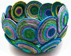 a bowl made out of paper with colorful circles on it's sides and bottom