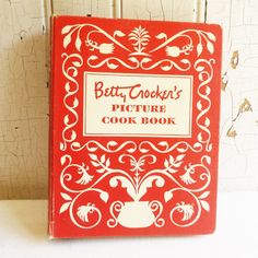 the betty cooke's picture cook book is red and white