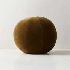 a large brown ball sitting on top of a white table