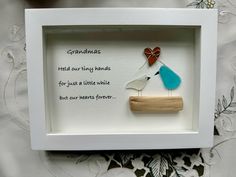 a white frame with two birds in it and a poem written on the front inside