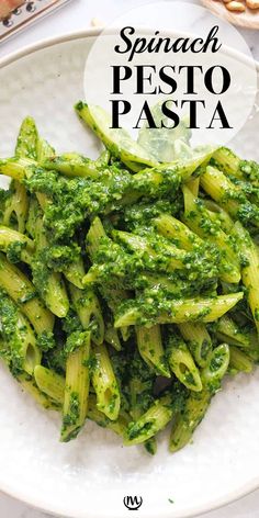 spinach pesto pasta on a white plate with the words spinach pesto pasta