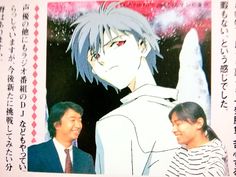 two people standing next to each other in front of a poster with anime characters on it