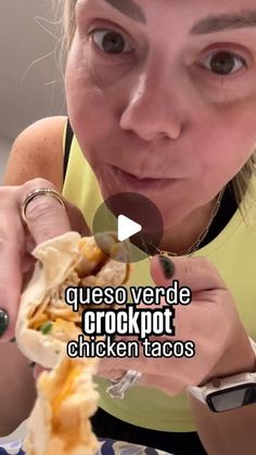 a woman is eating a chicken taco