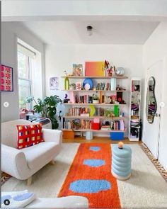 a living room filled with lots of furniture and bookshelves