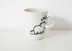 a coffee cup with an elephant drawn on it