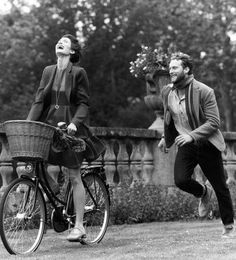 a man riding a bike next to a woman