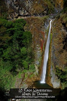 a waterfall in the middle of a forest