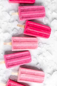 pink popsicles are lined up in the snow