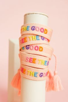 a stack of bracelets with words on them