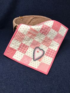 a pink and white checkered cloth with a heart on it