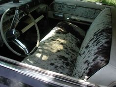 the interior of an old car with black and white spotted upholster