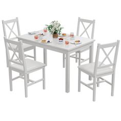 a white table with four chairs around it