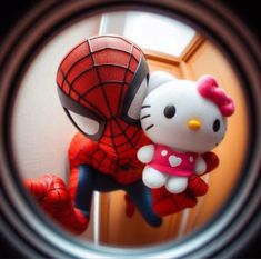 a hello kitty doll is posed as a spider - man