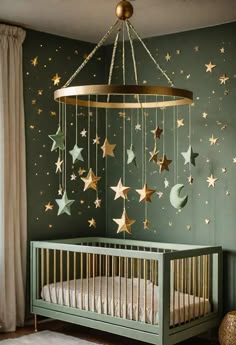 a baby crib with stars and moon decorations hanging from the ceiling