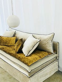 a couch that has some pillows on it