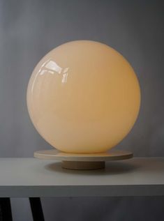 an egg shaped light sitting on top of a table