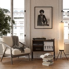 a living room filled with furniture and a painting on the wall next to a window