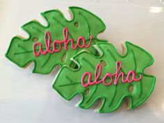 two decorated cookies with the words aloha and aloha written on them