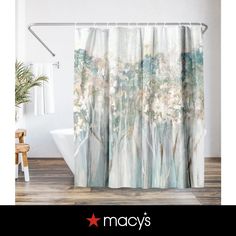 a shower curtain with an image of trees and flowers in the woods on it's side