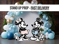 mickey and minnie mouse standing next to each other in front of balloons with the words stand up prop - fast delivery