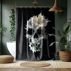 a black and white skull shower curtain with flowers on the front, hanging in a bathroom