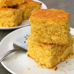 two plates with pieces of cornbread on them and one plate has a fork in it