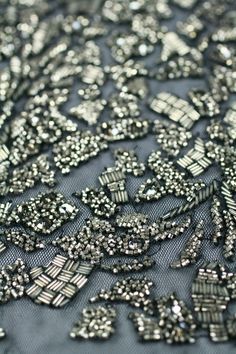 "Welcome to BYMODAARTISANS! This handmade beading design is made using unique hand made Antique Silver Color Beads ,Gunmetal Beads and Sequins and Black Diamond Crystals. Its truely elegant and perfect for a cocktail Dress or a mermaid Dress for a special occasion. Moda Artisans is a group of master craftsmen in India. Our work is truly a labor of love as each piece is entirely handmade using only the best quality fabrics, beads, sequins and crystals. All of our embroideries are handmade, NOT ma Festive Silver Sequin Fabric With Rhinestones, Silver Sequin Fabric With Rhinestones For Festive Occasions, Silver Beaded Sequin Fabric For Party, Textile Decoration, Meme Costume, Beading Design, Ruffle Fabric, Color Beads, Beaded Applique