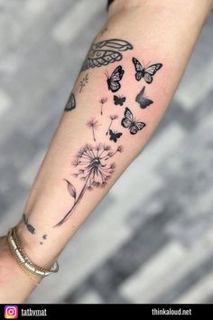 a woman's arm with butterflies and dandelions tattoo on the left forearm