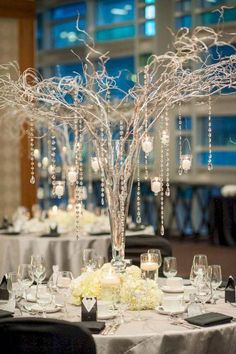 the centerpieces are decorated with crystal beads and branches, which stand on top of each other