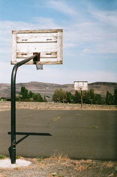 an empty basketball court in the middle of nowhere