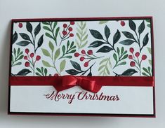 a merry christmas card with red ribbon and green leaves on it, which reads merry christmas