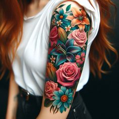 a woman with red hair wearing a white shirt and black shorts has a colorful flower tattoo on her arm