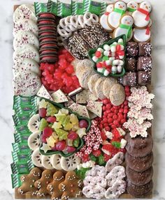 an assortment of christmas cookies and pastries on a board