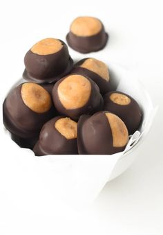 chocolate covered donuts in a white bowl