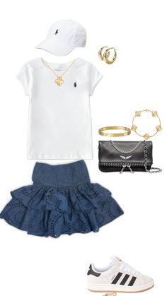 a white tee shirt, blue skirt and tennis shoes are featured in this fashion photo