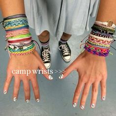 two hands with different colored bracelets on them