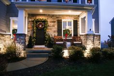 a house decorated for christmas with wreaths and lights