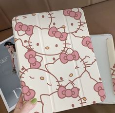 someone is holding an ipad case with hello kitty designs on the front and back cover