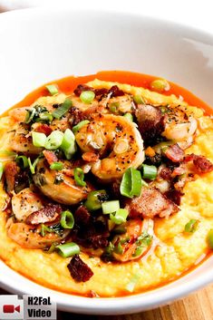 shrimp and grits in a white bowl on top of a wooden table with text overlay that reads southern shrimp and grits