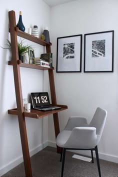 a ladder leaning up against a wall next to a desk with a laptop on it