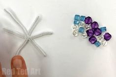 someone is making something out of beads and string to make it look like a snowflake