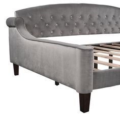 an upholstered bed frame with wooden slats and buttons on the headboard