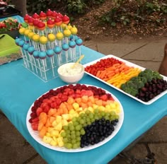 a table topped with lots of different types of candies and cupcakes on top of plates