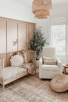 a baby's room with a crib, chair and rug