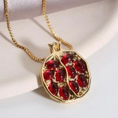 “Persephone” Greek Goddess Pomegranate Seed Garnet Deep Wine Red Stone Nestled Seeds In Halved Fruit Fertility Gold Elegant Fancy Classy Chic Luxurious Upscale Gold Necklace. By Eating A Few Pomegranate Seeds, Greek Goddess Persephone Tied Herself To Hades (& The Underworld)The Pomegranate Being A Symbol Of The Indissolubility Of Marriage. This Pendant Displays An Image Of A Halved Pomegranate With Gold Fruit Body & Wine Red Garnet Seeds, Even With Their Characteristic Seed Shape. With An Abstra Gold Pomegranate Necklace, Heart On Fire Jewelry, Pomegranate Cross Stitch Pattern, Garnet Stone Necklace, Persephone Party Theme, Pomegranate Seed Jewelry, Garnet Jewelry Necklaces, Persephone Decor, Elegant Necklaces Gold