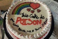 this cake is decorated with white frosting and has rainbows on the top, which reads, this cake is prison