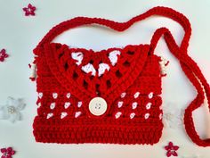 a red crocheted purse sitting on top of a table